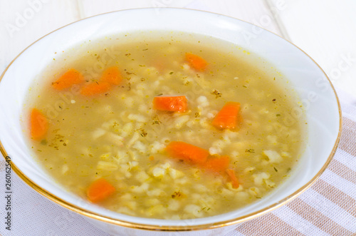 Vegetable broth with brown rice and carrots.