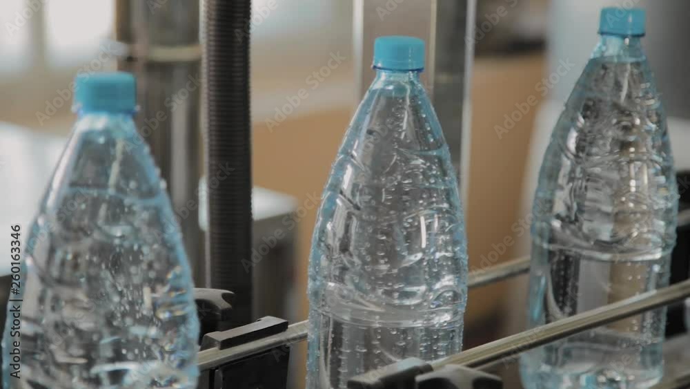 Plastic bottle manufacturing line. Plastic molding bottling factory. Blanks of plastic bottles in the factory.
