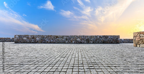 Empty floor and beautiful sky with stone wall at sunset