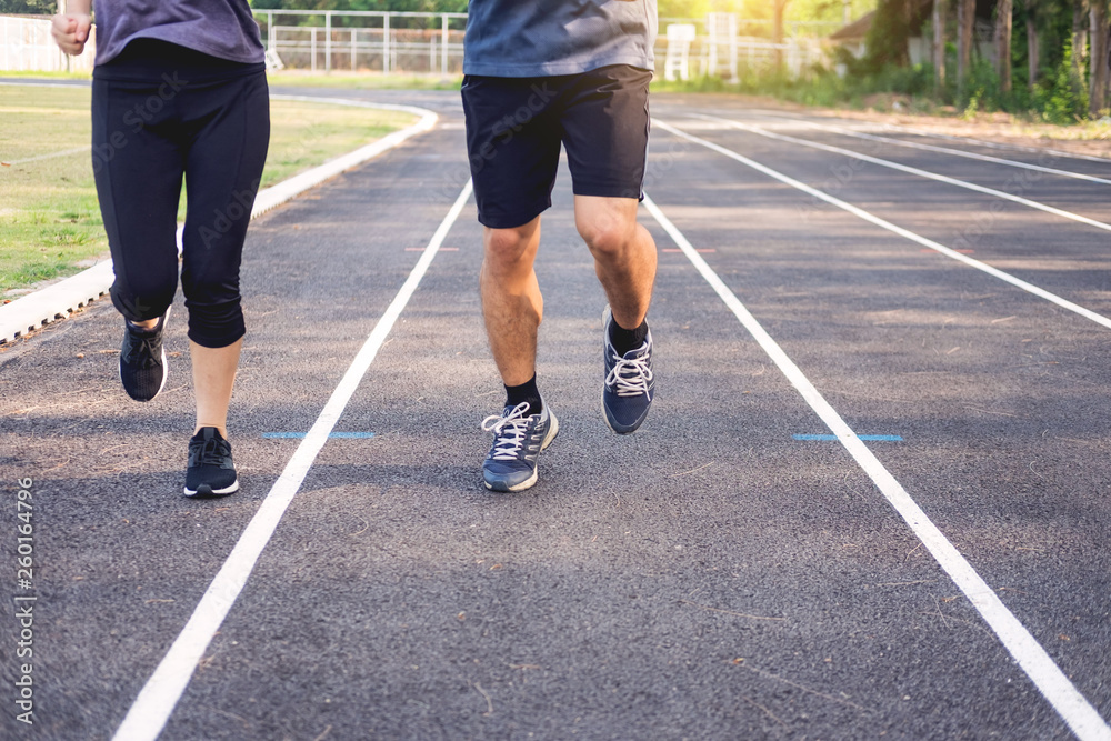 Early morning workout, Fitness couple stretching outdoors in park. Young man and woman exercising together in morning, Living healthy lifestyle fitness, sport concept.
