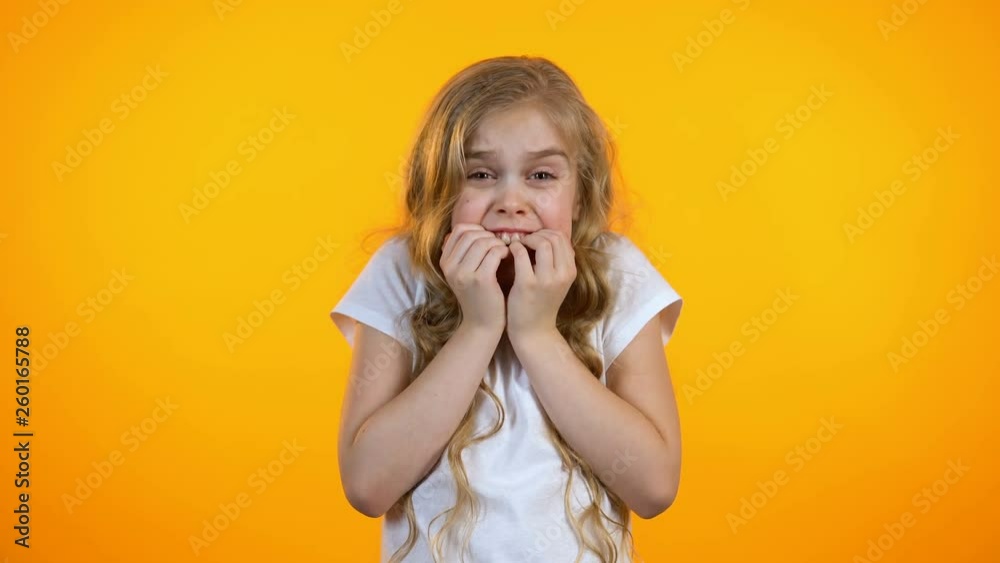 Extremely frightened schoolgirl looking around, childish fears, psychology