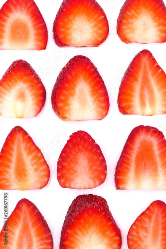 Plate of sliced strawberries isolated on white background. Strawberry berry on a white background. Neatly arranged slices of red strawberry on a white background.