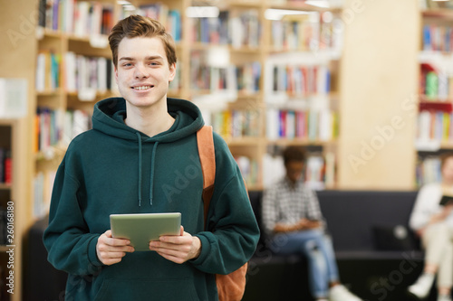 Photos Cheerful confident handsome high school student with satchel standing in modern