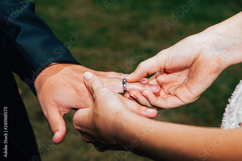 Closeup shot of the exchange of wedding or engagement ring