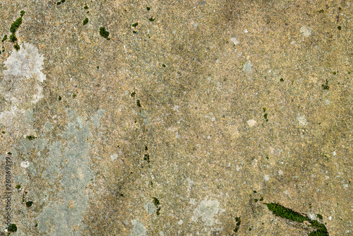 Textured natural background of weathered stone with lichen and moss