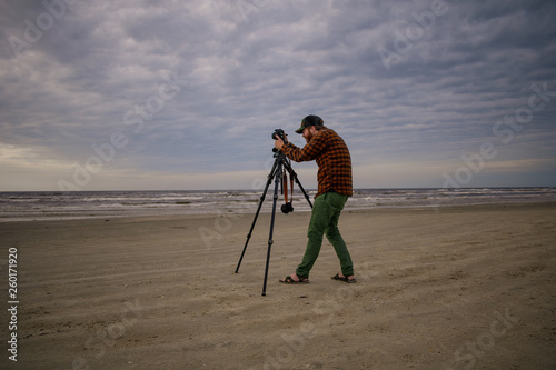 Beach Photographer Setting Up Equipment on the Bay