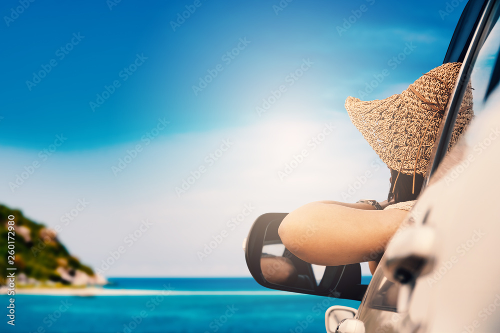 Fototapeta premium Happy woman sitting in the car and traveling summer season on the sea resting and special day to vacation.