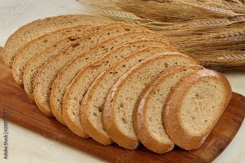 Bread,Plenty of sliced bread background, Bakery and grocery concept. Fresh, healthy sorts of rye and white loaves, sprinkled flour on sackcloth and rustic wood table, food closeup.