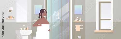 fat obese woman wrapped with white towel overweight african american girl standing in bathroom after shower obesity concept modern apartment interior horizontal portrait