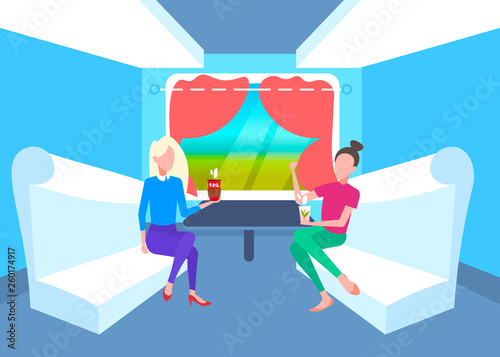 two women sitting together in train compartment passengers discussing drinking tea during vacation trip railway transport traveling concept flat full length horizontal