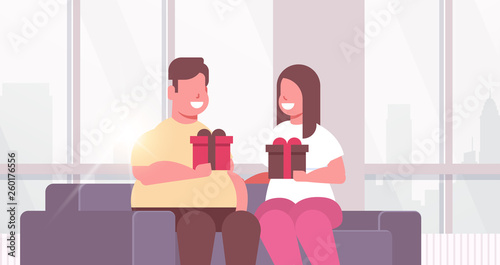 Fat obese couple holding wrapped gift boxes