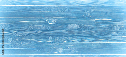 Light blue wood textured background. Wooden planks on a wall or floor with grain and texture.