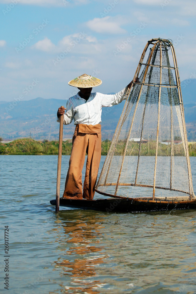 fisherman fishing with net on inle lake -myanmar