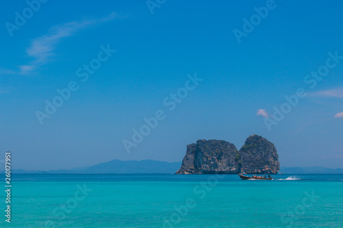 Boat floating on ocean island in Thailand