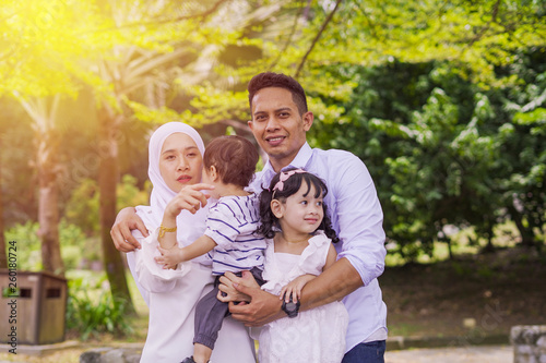 Lovely young couple with their kids, son and daughter. Happy family at park. Parenting, caring concept. © SafwanAbdRahman