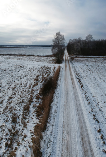 Country road through a wintry landscape, aerial © Alis Photo