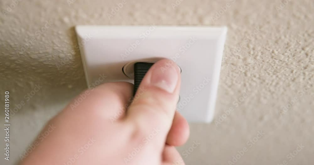 Close Up of Man's Hand Plugging Cord Into Electrical Outlet Then Unplugging in Slow Motion