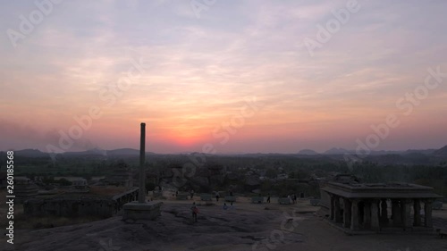 Panoramic view of ruins of temple complex, stone tower and natural landscape in Hampi, Karantaka, the ancient capital of Vijayanagara Empire in south India, during a beautiful sunset time, static shot photo