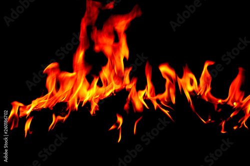 Flame burning at night on a colored background