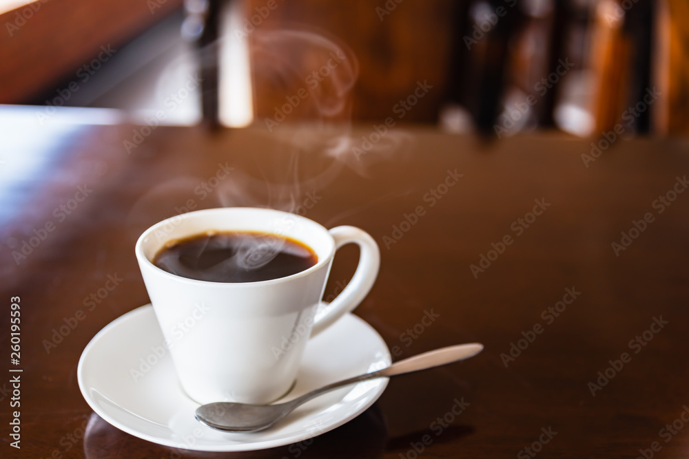 Hot black coffee in a white coffee's cup with steam. Hot black coffee in a white coffee's cup with steam.