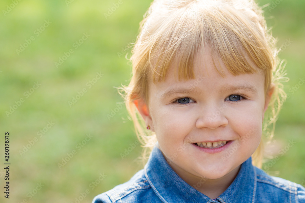 portrait of happy little girl with smile on face on sunny day portrait of happy little girl with smile on face on sunny day
