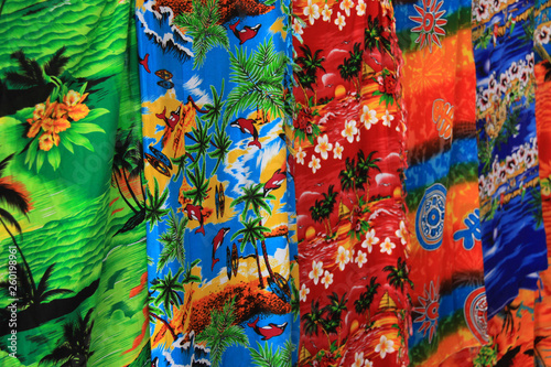 Colorful sarong scarves hanging on display in a market