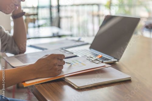 Office man reading financial document at workplace