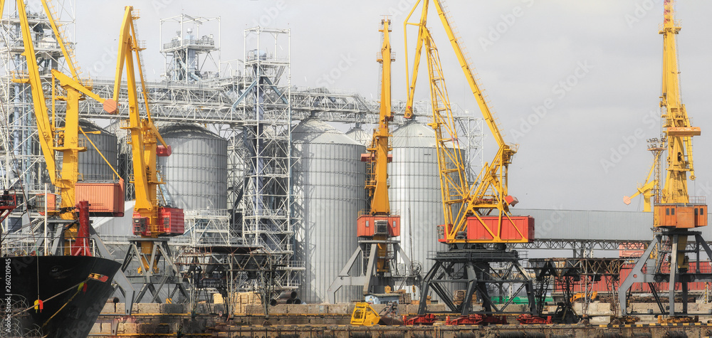 Lifting cargo cranes, ships and grain dryer in Sea Port of Odessa, Black Sea, Ukraine Lifting cargo cranes, ships and grain dryer in Sea Port of Odessa, Black Sea, Ukraine