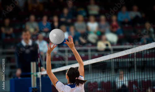 Girl Volleyball player and setter setting the ball for a spiker during a game