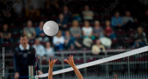 Girl Volleyball player and setter setting the ball for a spiker during a game photo