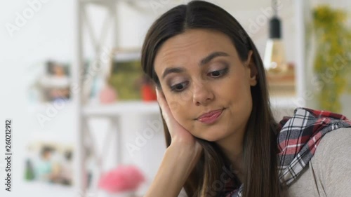 Young woman checking credit card expenses for month, lack of budget, squandering