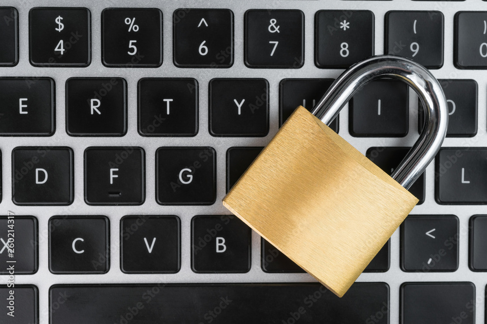Padlock on a laptop computer keyboard. Cyber security abstract concept. Padlock on a laptop computer keyboard. Cyber security abstract concept.