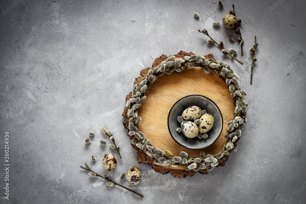 Quail eggs and pussy willow wreath as a symbols of spring and Easter with a copy space, dark mood Quail eggs and pussy willow wreath as a symbols of spring and Easter with a copy space, dark mood