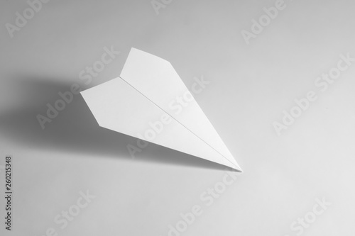 paper airplane on pastel background. Minimal flat lay school concept.