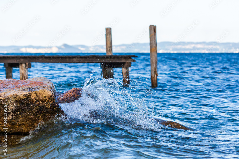 Fototapeta premium Splash of wave on Garda lake, Italy