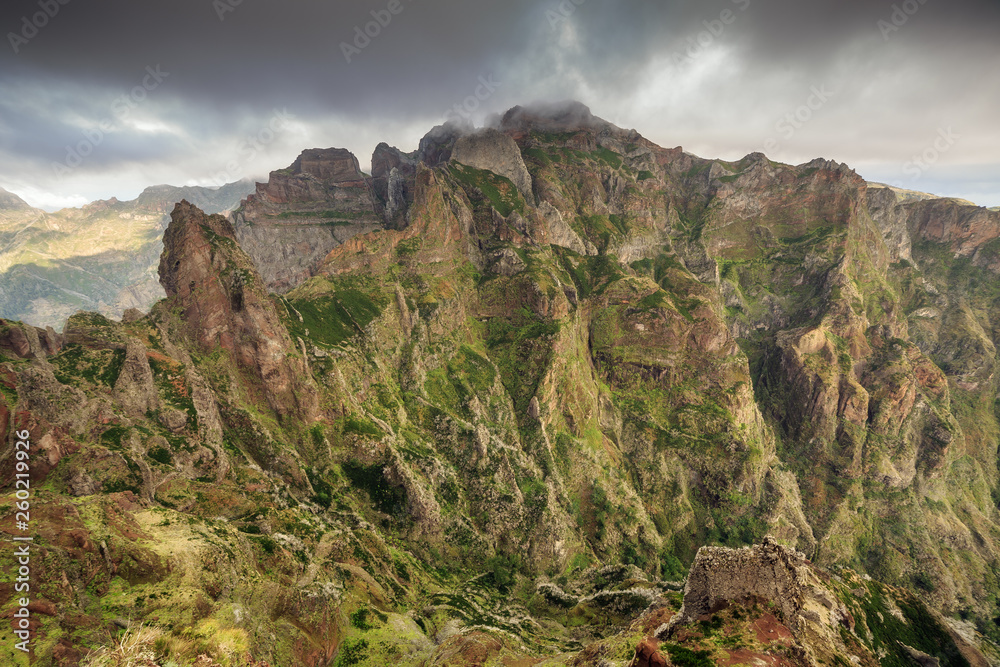 Naklejka premium Beautiful panorama view of the landscape in the mountains of Madeira at Pico do Areeiro (Arieiro) while hiking to Pico Ruivo on a cloudy summer day
