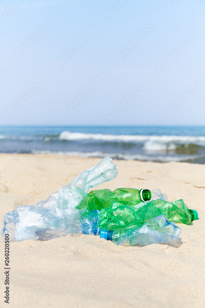 Used plastic bottles on a beach, selective focus. Used plastic bottles on a beach, selective focus.