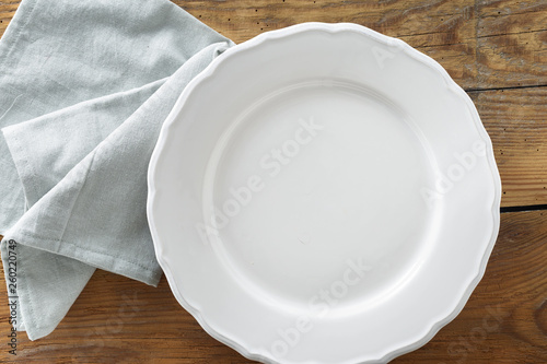 Empty plate with napkin top view rustic style