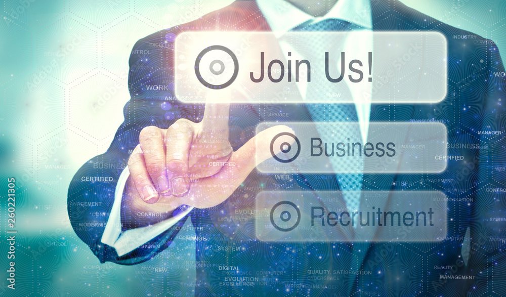A business man selecting a button on a futuristic display with a Join Us concept written on it. A business man selecting a button on a futuristic display with a Join Us concept written on it.