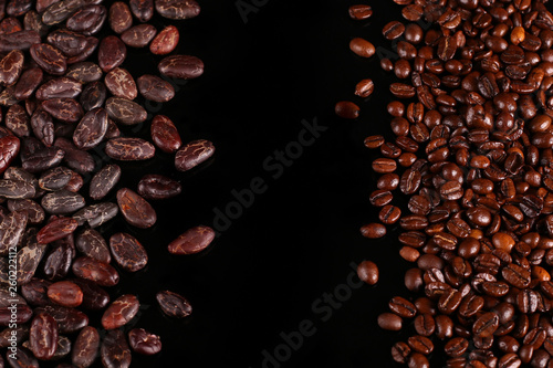 Roasted beans. Cocoa beans and coffee beans isolated on black background.