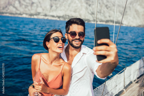 Couple in love on a sail boat in the summer make selfie. © Mediteraneo