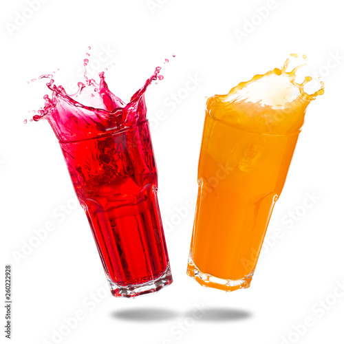 Couple orange juice and red soda splashing out of glass isolated on white background.