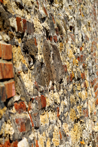 old stone and brick wall in perspective