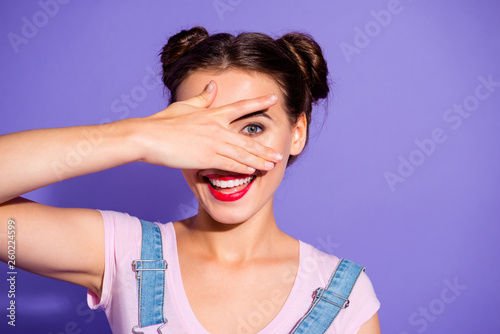 Close up photo beautiful amazing she her lady two hair buns perfect white teeth hide face eye look interested curious wear casual t-shirt jeans denim overalls clothes isolated purple violet background