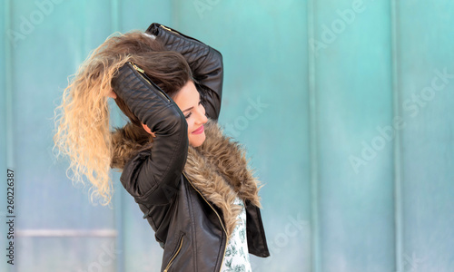 Beautiful young woman play her hair