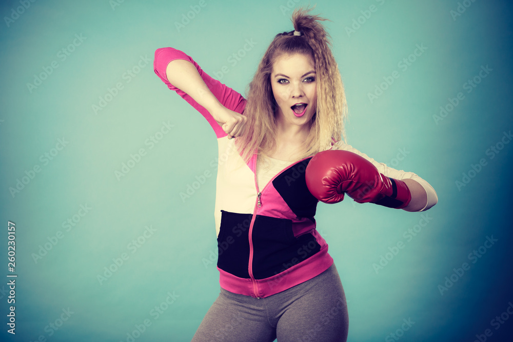 Funny girl in red gloves playing sports boxing Funny girl in red gloves playing sports boxing