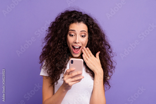 Close-up portrait of nice attractive lovely cheerful wavy-haired lady holding in hand cellular sale discount buying online purchase shopping isolated on bright vivid shine violet pastel background