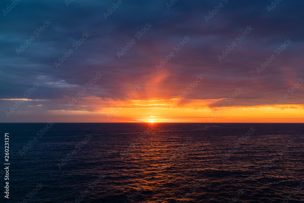 Cloudy sunrise view over the ocean horizon. Cloudy sunrise view over the ocean horizon.