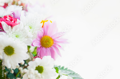 Beautiful bouquet of flowers on the white background. Chrysanthemum and wild roses. Space for a text. Close up.