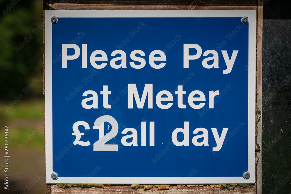 Sign: Please pay at meter, seen in Malmsmead in Devon, England, UK